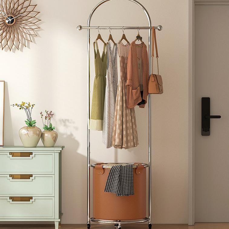 Pootoo's Mobile Round Floor Coat Rack with Laundry Bag displayed in the bedroom, offering convenient storage space. The round design adds a touch of modernity to the bedroom.