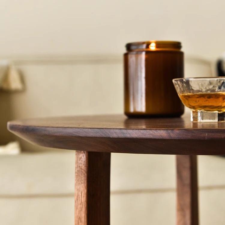 POOTOO's Vintage Solid Wood Round Side Table Coffee Table with Candles Display Image Highlighting the warm ambiance created by the candles atop this side table, perfectly complementing its rustic charm and enhancing your living space.