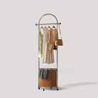 White Background Image of Pootoo's Mobile Round Floor Coat Rack with Laundry Bag, showcasing its unique round design and practical laundry bag feature, suitable for modern home settings.