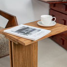 Pootoo's C-shaped Side Table paired with coffee and books, showcasing a relaxed lifestyle atmosphere. The table's minimalist design and practical functionality blend perfectly, ideal for enjoying reading time in a cozy corner.