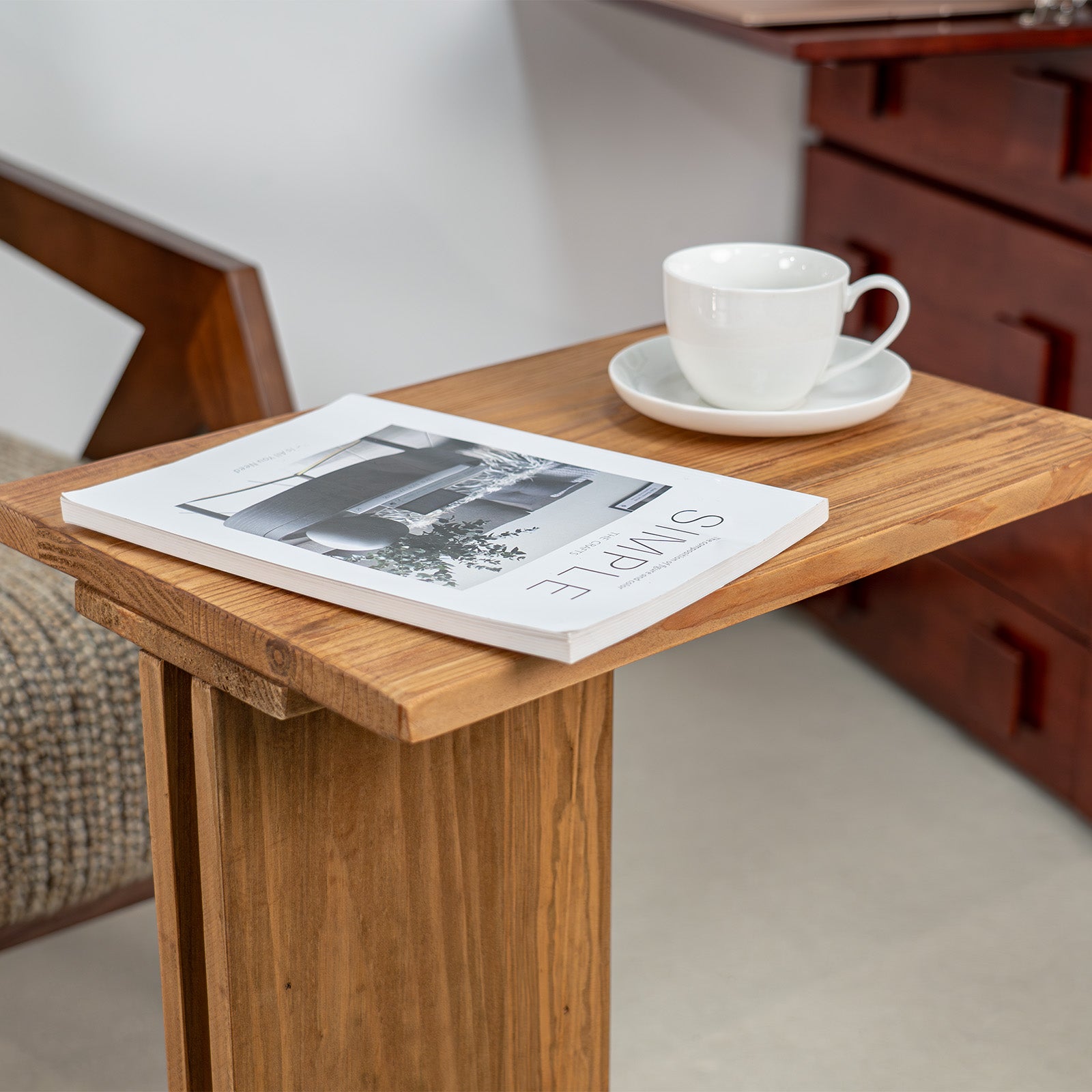 Pootoo's C-shaped Side Table paired with coffee and books, showcasing a relaxed lifestyle atmosphere. The table's minimalist design and practical functionality blend perfectly, ideal for enjoying reading time in a cozy corner.