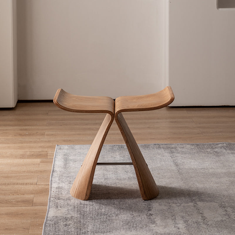 Front View of Pootoo's Butterfly Stool Displayed in the Living Room, with its elegant design and warm wood tones perfectly blending into the interior, serving both as a seat and a decorative piece.