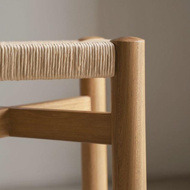 POOTOO's Solid Wood & Woven Straw Vintage Low Stool Side Detail Image Showcasing the intricate craftsmanship and design features, highlighting the sturdy structure and rustic appeal of this low stool.