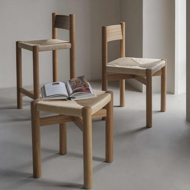 POOTOO's Solid Wood & Woven Straw Vintage Low Stool with Books Display Image Highlighting the functional design of this low stool, elegantly showcasing books on top while adding a rustic charm to your decor.